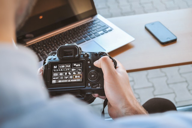 Person looking through settings on a DSLR camera